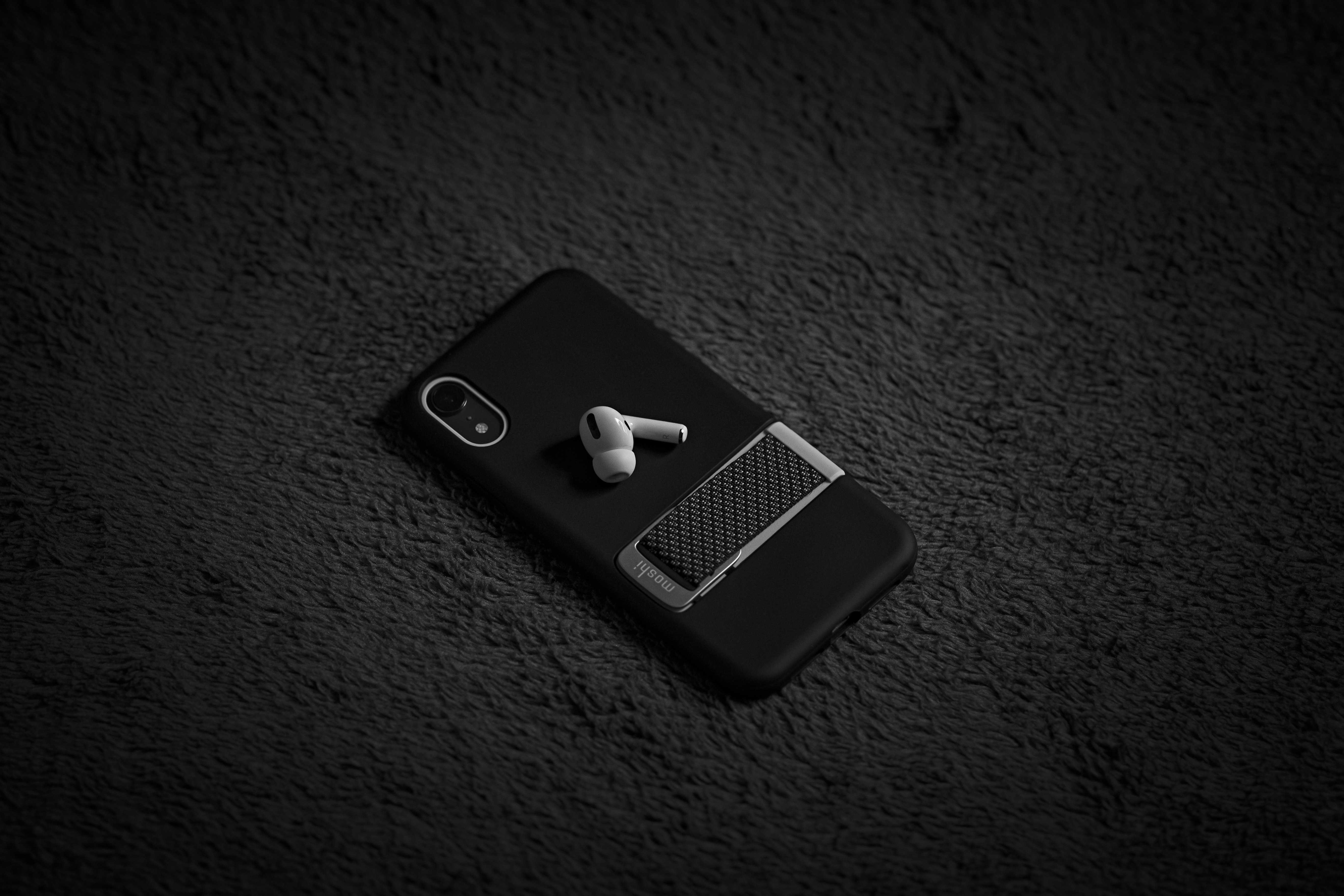 black iphone 4 on black textile